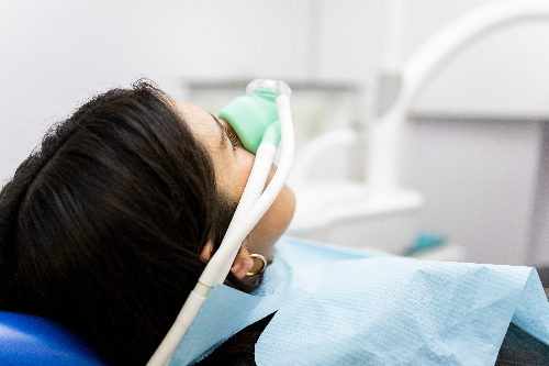 female patient undergoing sedation to easy anxiety before a dental procedure