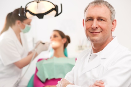 Smiling male dentist answers common dental questions