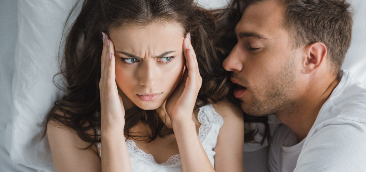 man snoring in his partners ear, sleep apnea sufferer