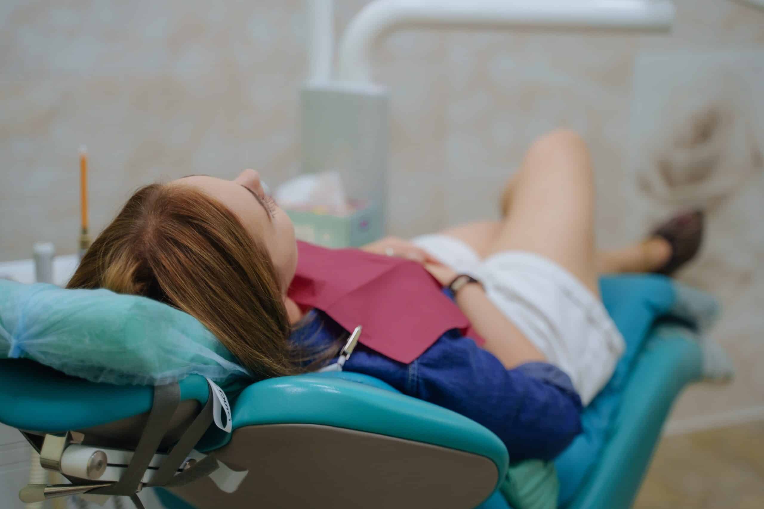 patient laying calmly in a dental chair, dental sedation